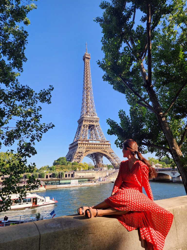 Min standing in front of the Eiffel Tower in Paris