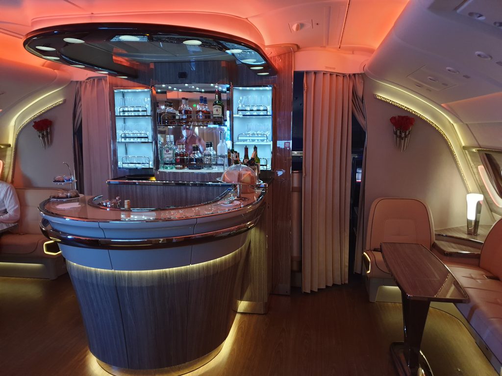 Drinks arranged on a counter in an Emirates aircraft cabin.