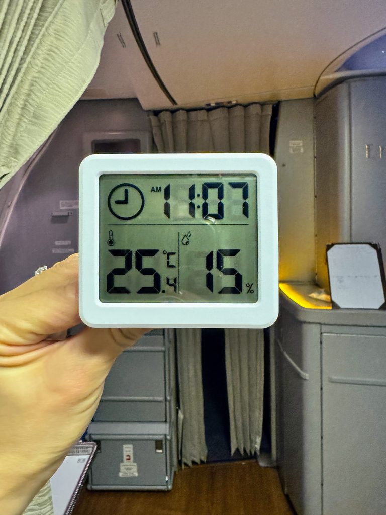 A digital meter showing low humidity inside an aircraft cabin.